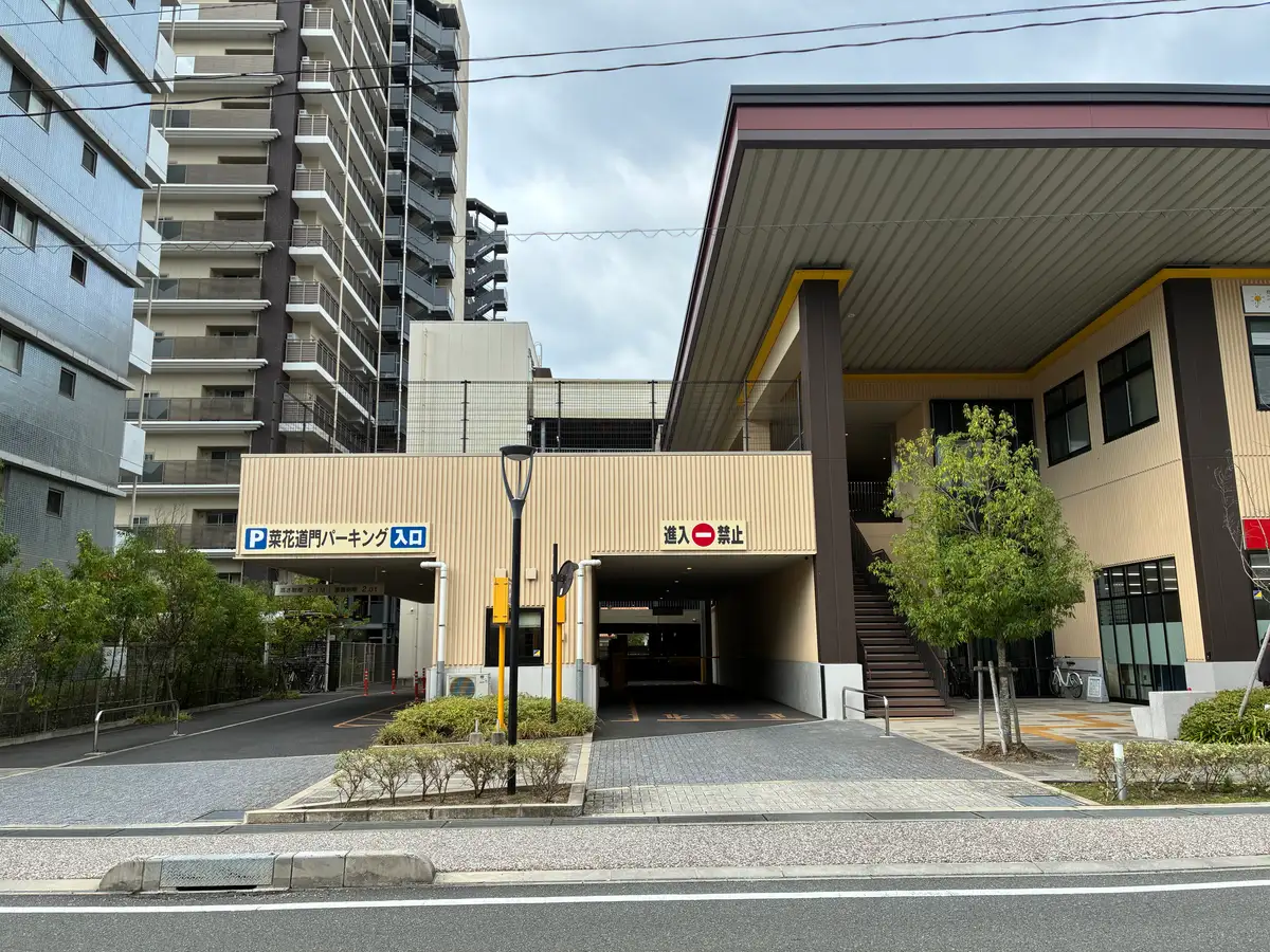 「菜花道門パーキング入口」と書かれた建物1階の入口